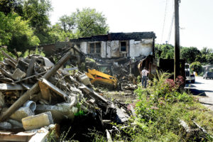 Dilapidated  building on Scotts Run Rd. in Osage is being torn down